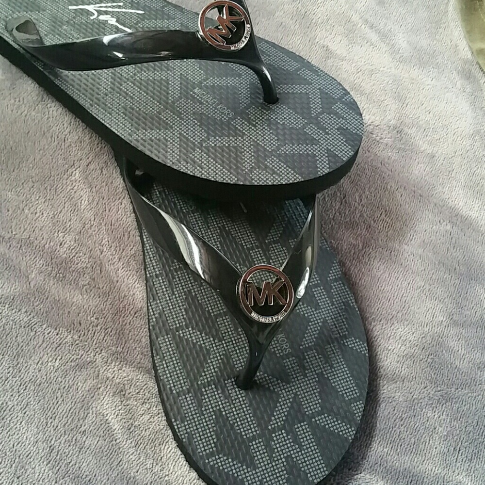 MK black flip flops